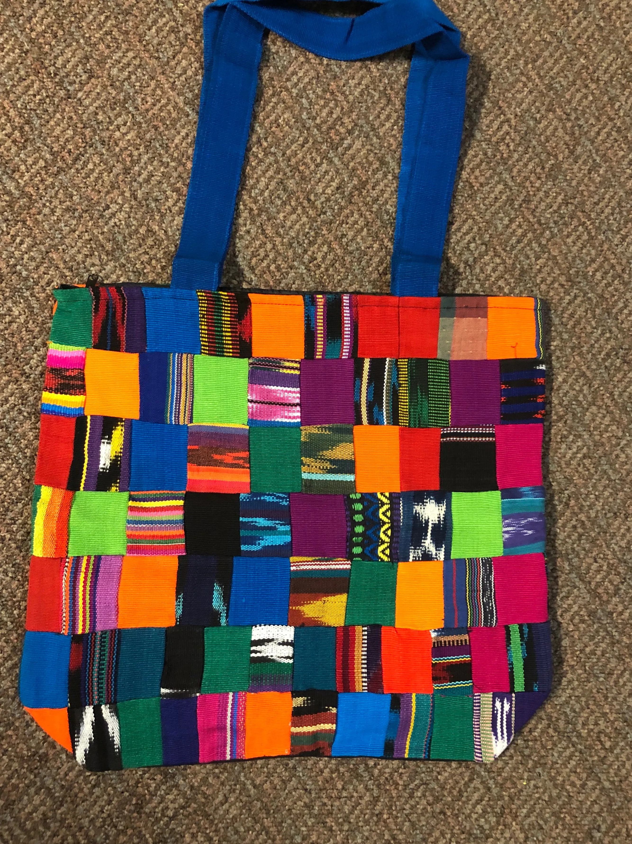 Handwoven Guatemalan cotton patches fashioned into a sturdy shoulder bag, fully lined with one zipper pocket. 15” x 17”