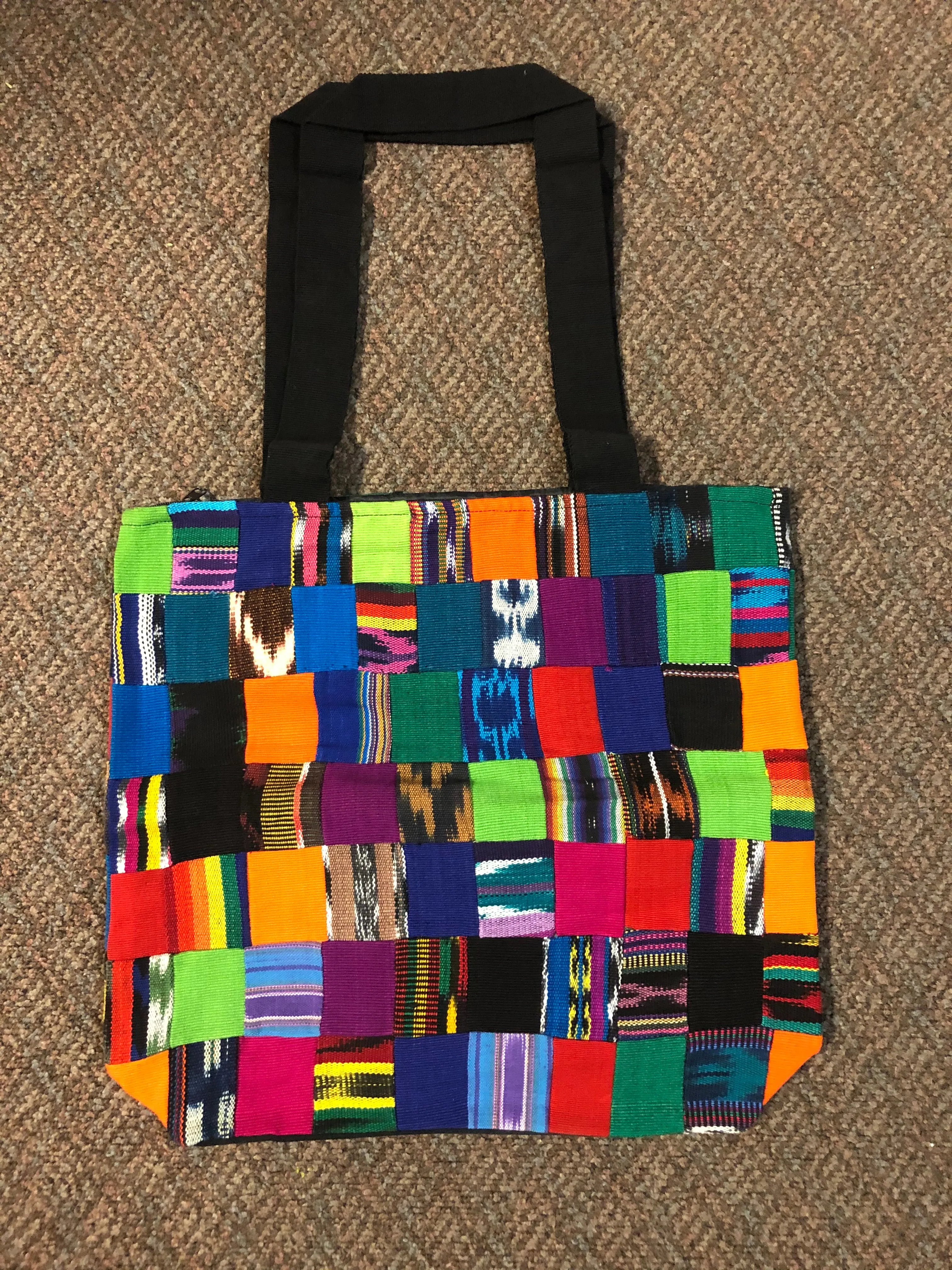 Handwoven Guatemalan cotton patches fashioned into a sturdy shoulder bag, fully lined with one zipper pocket. 15” x 17”