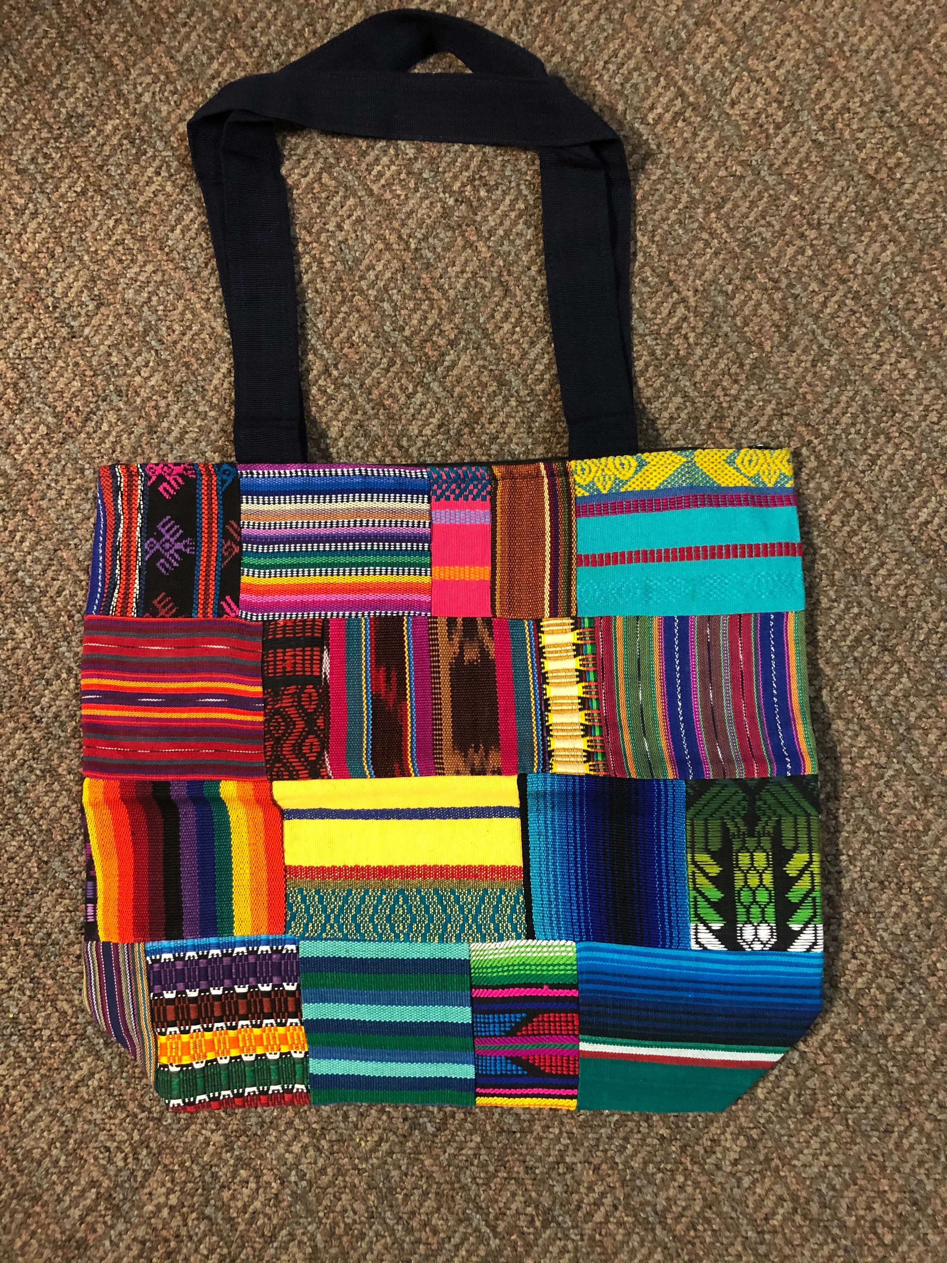 Handwoven Guatemalan cotton patches fashioned into a sturdy shoulder bag, fully lined with one zipper pocket. 15” x 17”