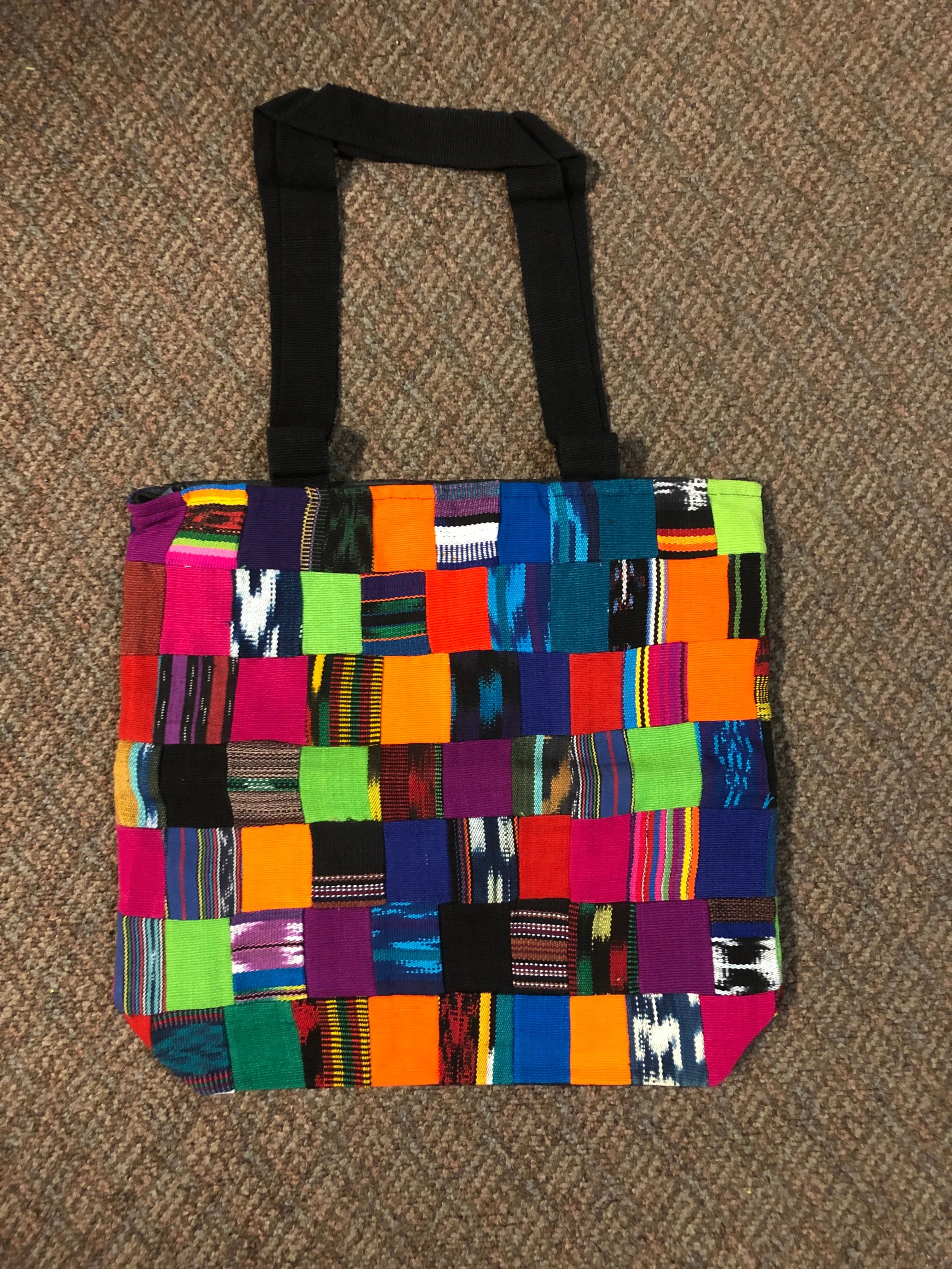 Handwoven Guatemalan cotton patches fashioned into a sturdy shoulder bag, fully lined with one zipper pocket. 15” x 17”